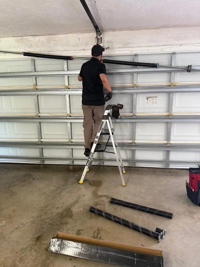 Spring components on the floor during overhead door work