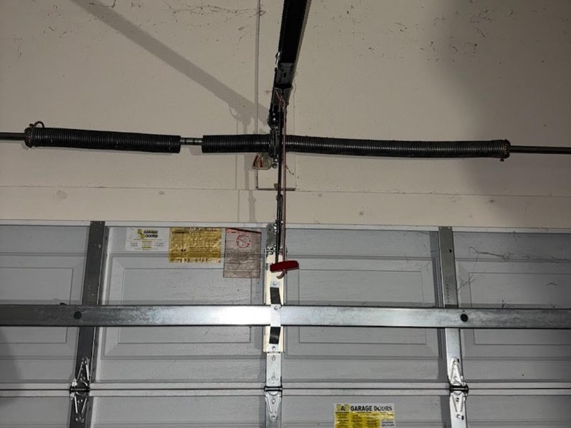 Torsion springs and center bearing above a sectional door